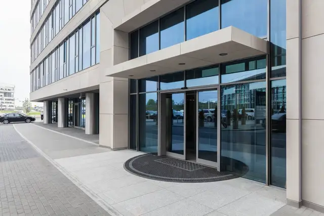 Commercial storefront entrance with glass double doors in a brick facade