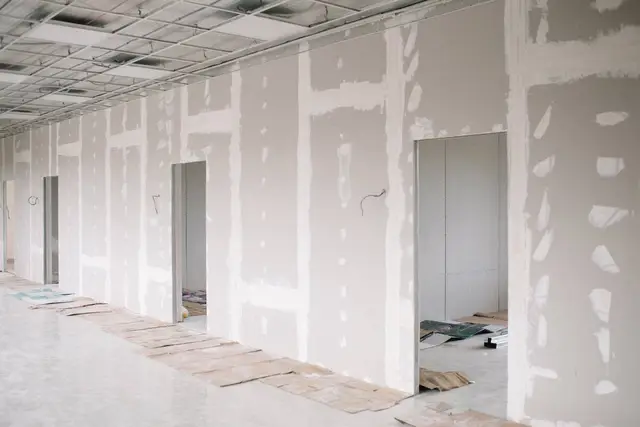 Contractor finishing a drywall joint with a taping knife