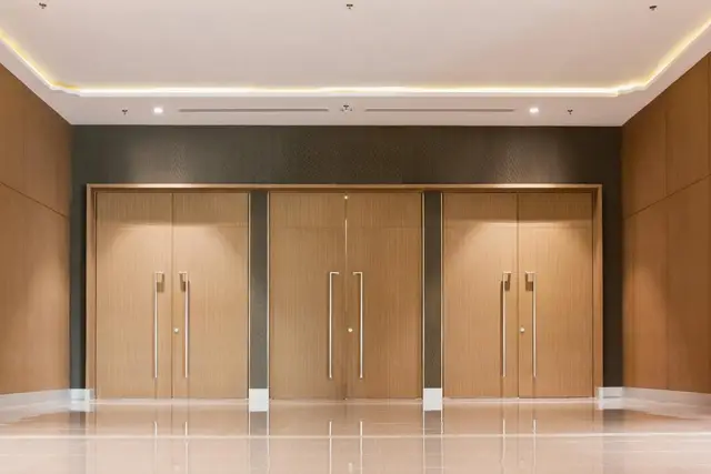 Modern office corridor with glass partition walls and doors