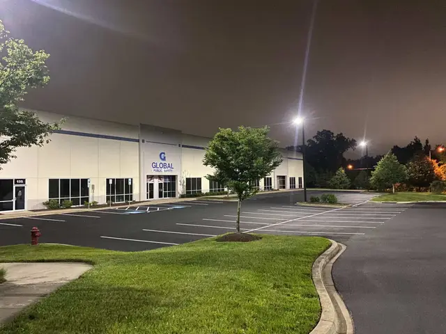 Freshly sealcoated and striped warehouse parking lot at night