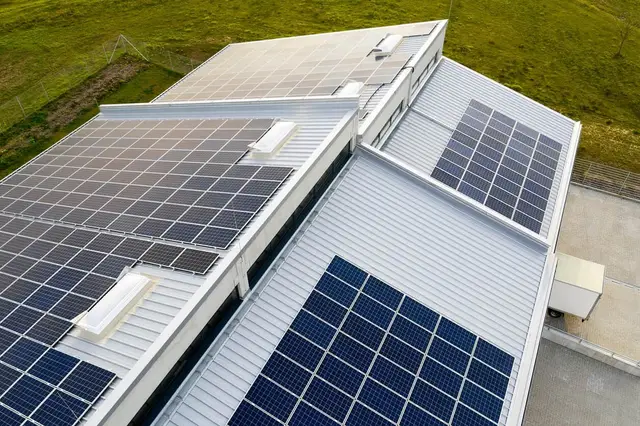 Solar panels being installed on a flat commercial roof