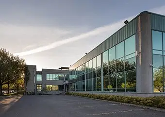 Modern office building with new glass windows at sunset