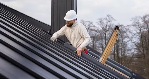 contractor adjusting metal shingles
