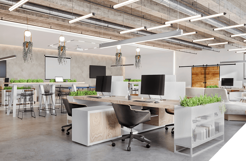 Open-plan office with commercial lighting, computers, ergonomic chairs, large desks; enhanced décor with plants, hanging lights, natural wood accents.