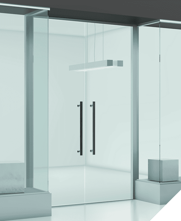 Modern minimalistic glass door with metal handles in a bright empty room, featuring a suspended rectangular light fixture; showcases impeccable interior door installation.