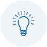 Blue lightbulb icon with rays on gray background representing innovation and commitment in renovation and construction services.