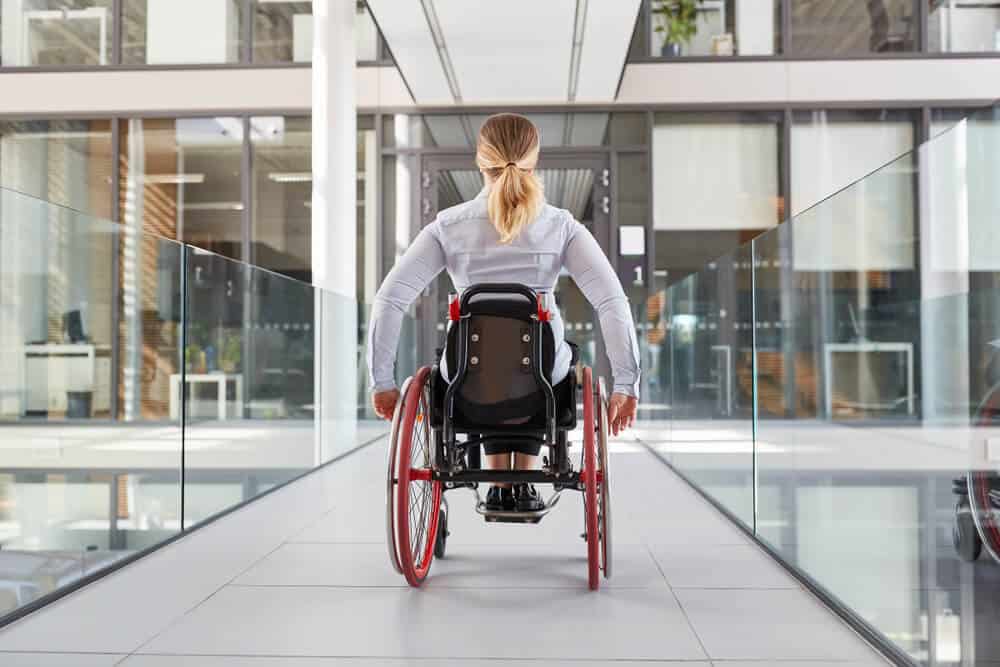 woman in wheelchair enter building ADA standards - commercial remodeling
