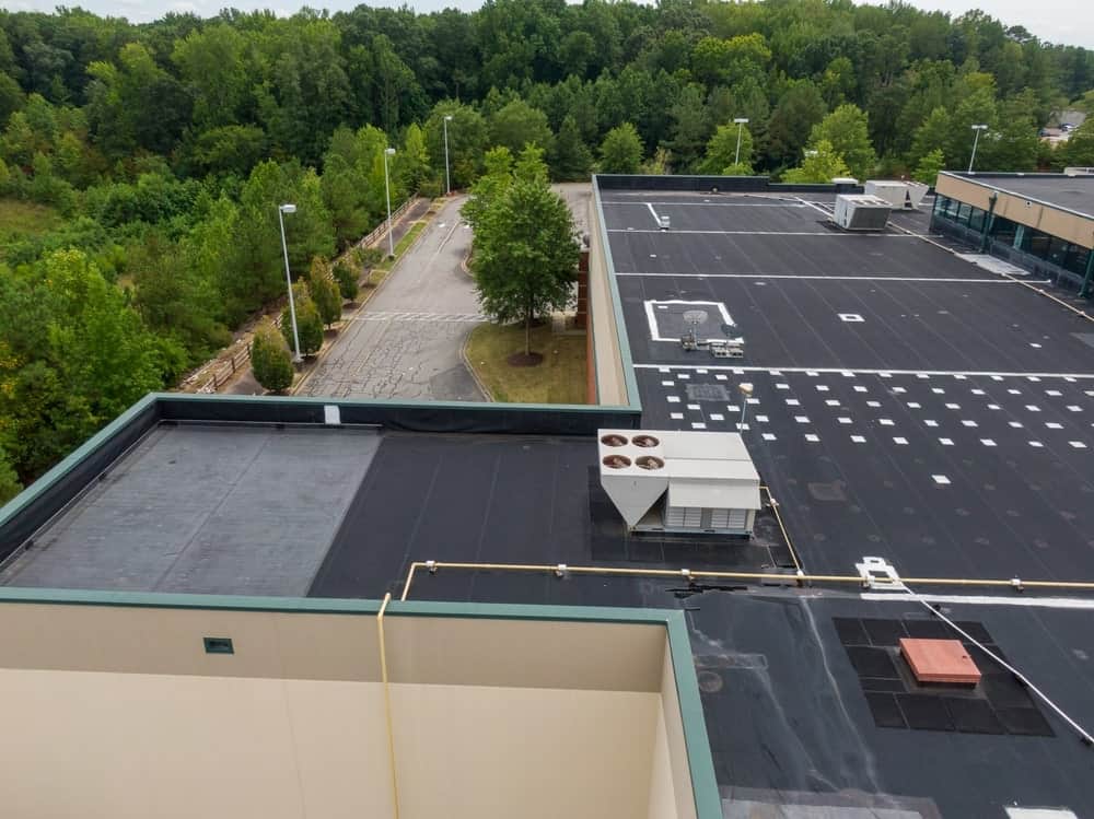 commercial building with black single-ply roofing material installed on top