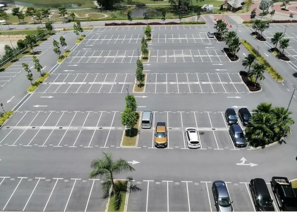 Large parking lot with clearly marked spaces and directional arrows