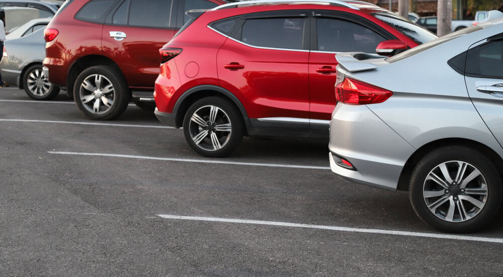 Cars parked in a parking lot with white lines.