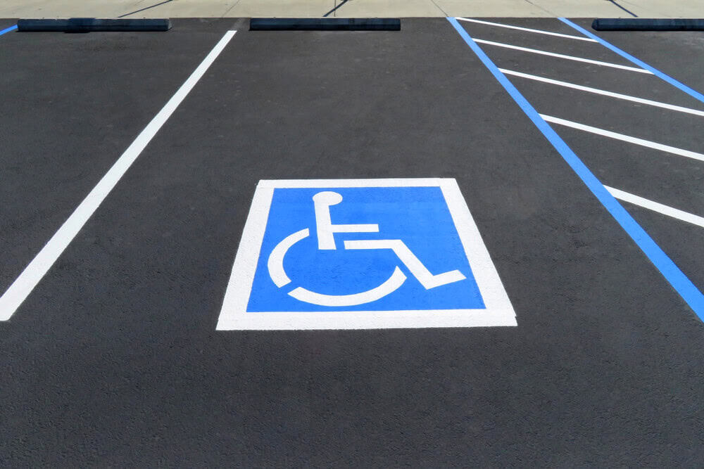 Accessible parking space with blue and white handicap symbol at commercial roofing facility in Bethesda.