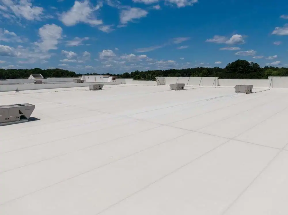 A freshly replaced single-ply roofing system installed on a commercial building