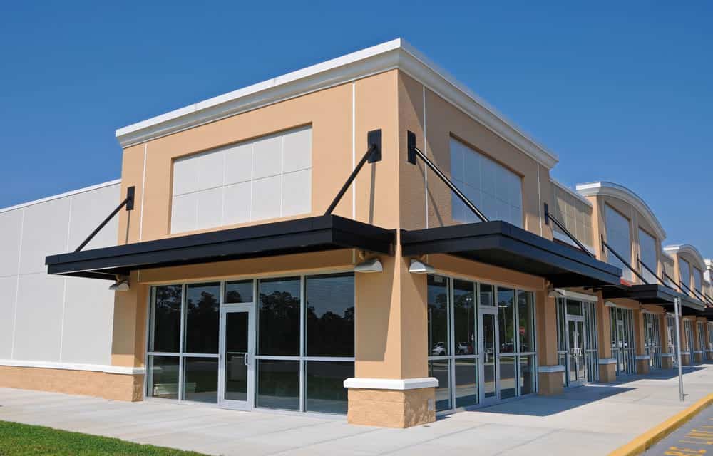 A strip-mall with matching storefronts on a sunny day