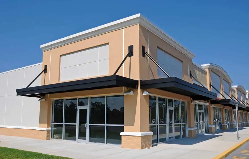 A strip-mall with matching storefronts on a sunny day