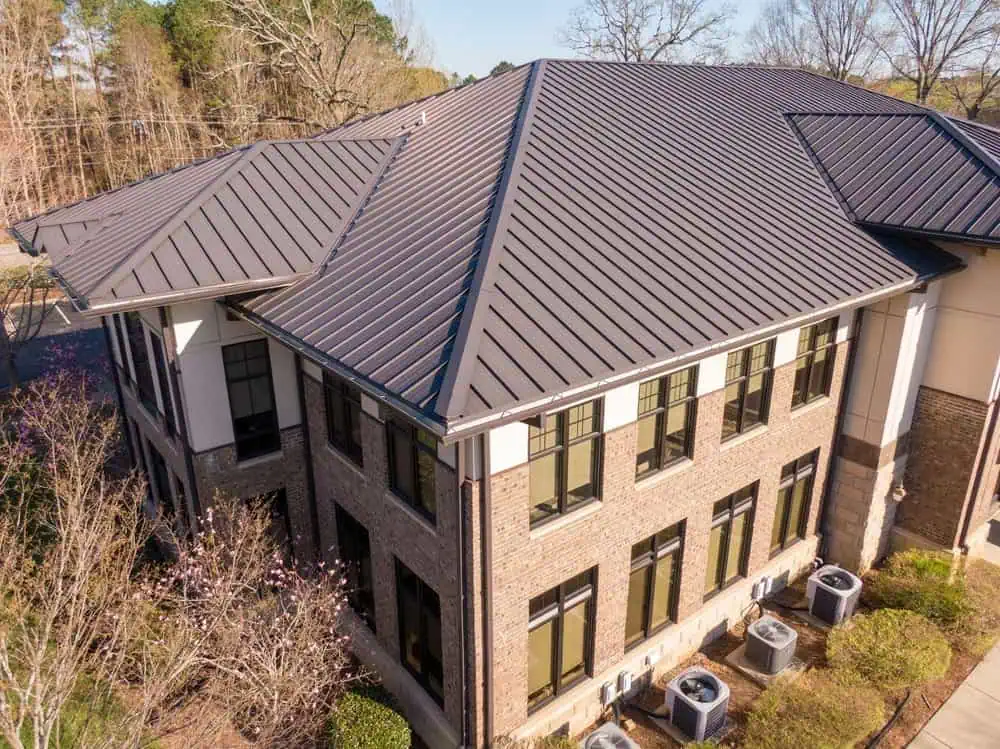 A commercial office building with a standing seam metal roof
