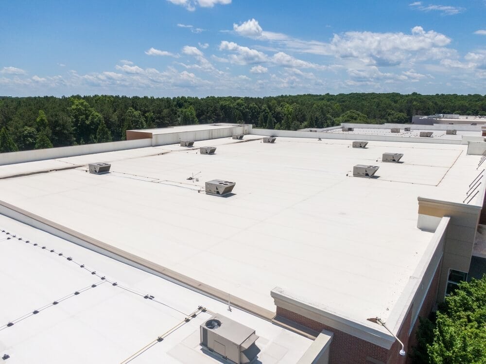 A white TPO membrane on a large commercial facility roof