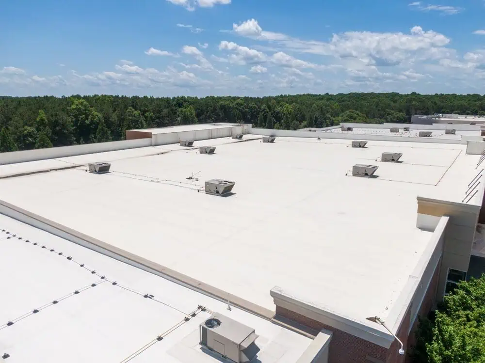 A white TPO membrane on a large commercial facility roof